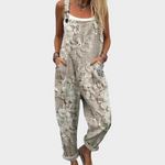 Light gray loose-fit overalls with floral print, adjustable bib straps and front pockets