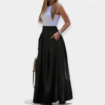 Black midi skirt with pleated A-line design and wide waistband