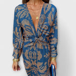 Elegant long-sleeve V-neck dress with blue and gold ornate pattern, front knot detail