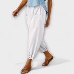White harem pants with side pockets and button-tab cuffs, relaxed loose fit