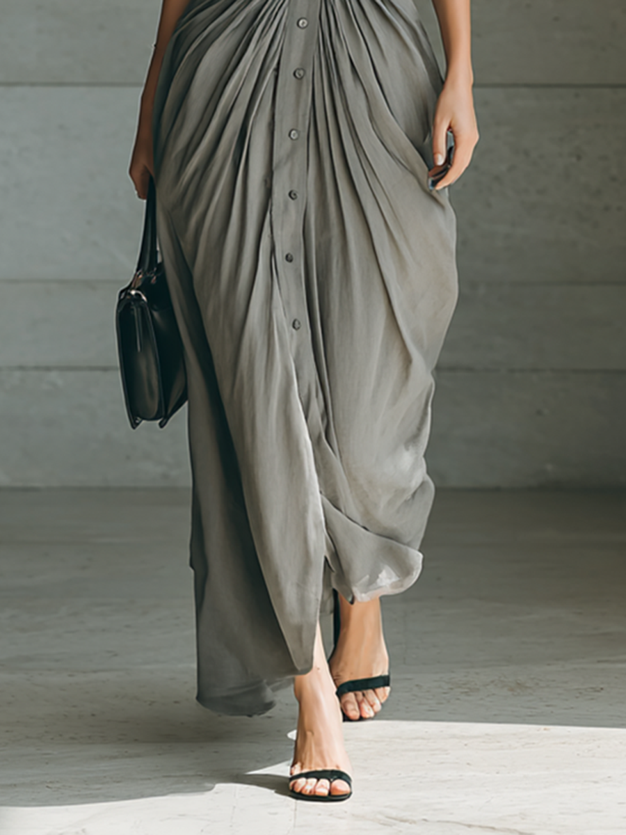 Long grey pleated dress detail with button placket and draped side folds