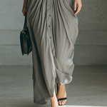 Long grey pleated dress detail with button placket and draped side folds