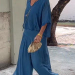 Two-piece chiffon set with V-neck blouse and wide-leg pants, medium blue.