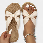 Women's wide bow sandals in cream with braided footbed and large knotted bow front