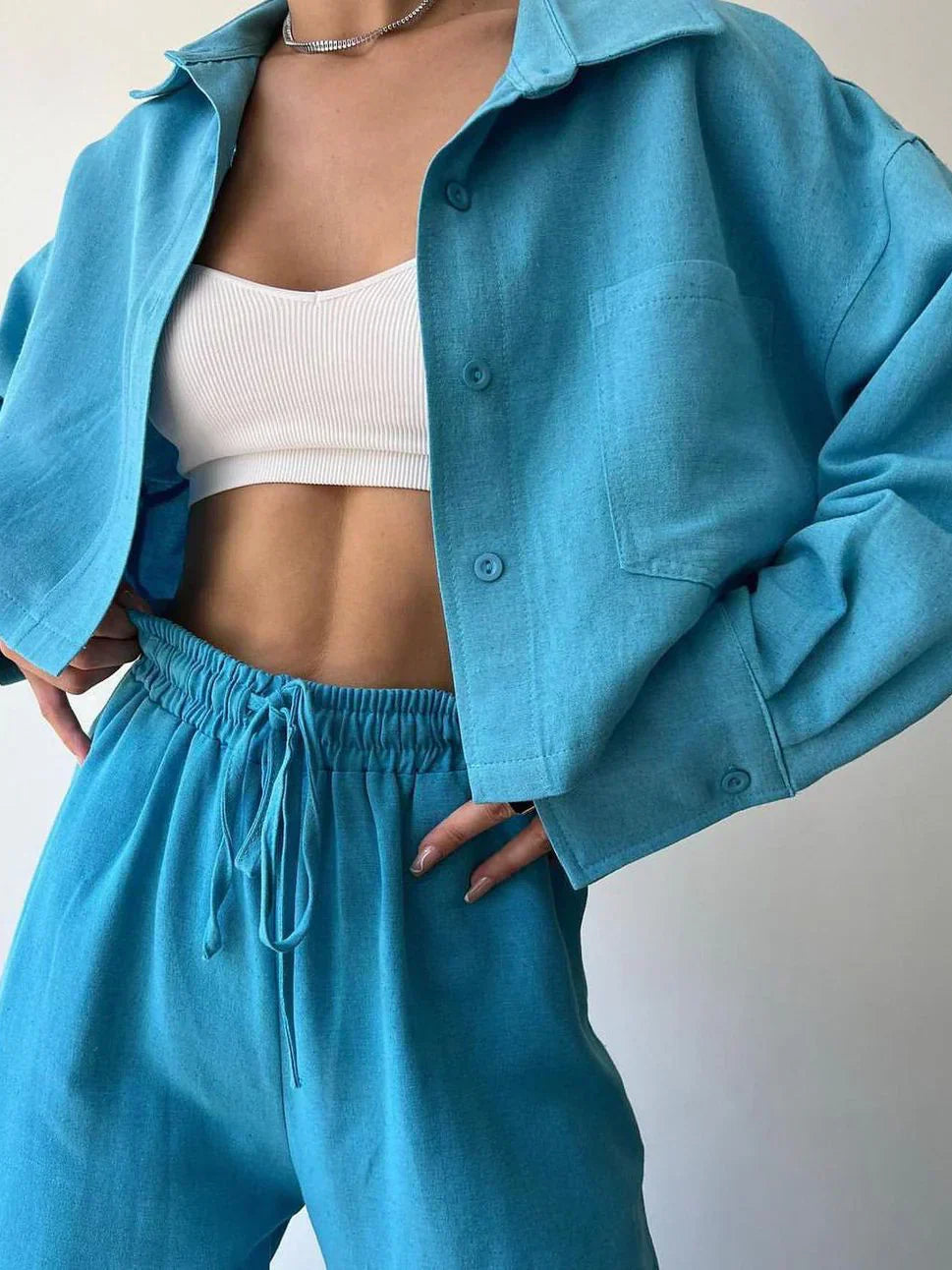 Teal-blue two-piece set: collared button-up top and drawstring waist pants
