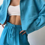 Teal-blue two-piece set: collared button-up top and drawstring waist pants