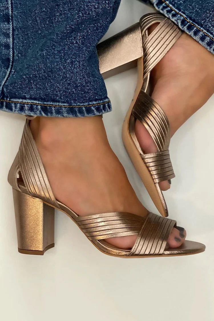 Metallic bronze strappy sandals with block heel and toe ring.