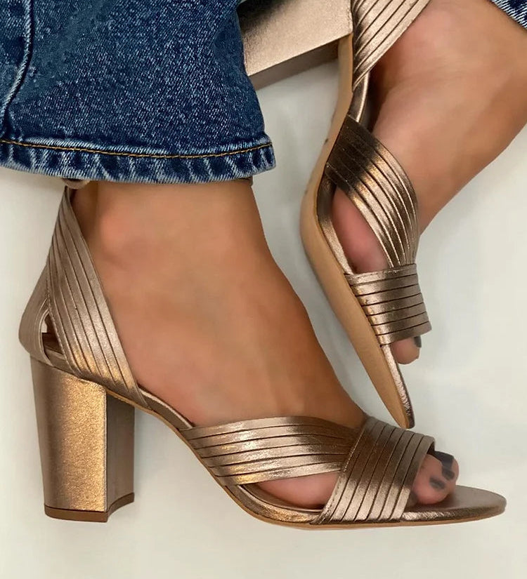 Metallic bronze strappy sandals with block heel and toe ring.