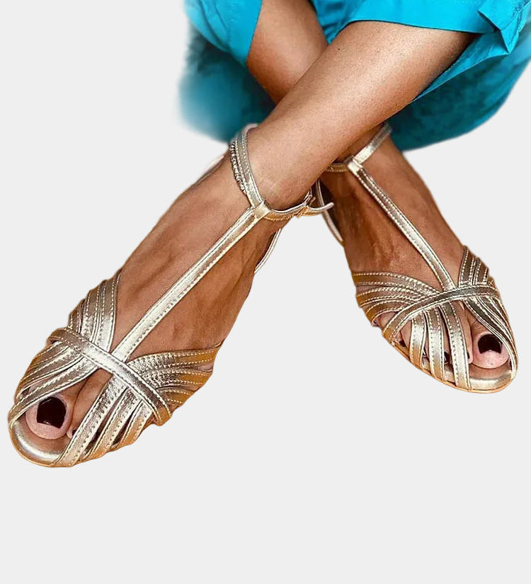 Gold strappy sandals with crossover straps and open toe, ankle buckle closure