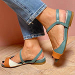 Teal ankle-strap sandals with open toe, orange heel detail, and adjustable straps
