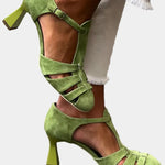 Green heeled sandals with ankle strap, open toe, and multiple crisscross straps