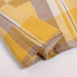 Long-sleeve plaid shirt cuff in yellow, tan, brown, and white