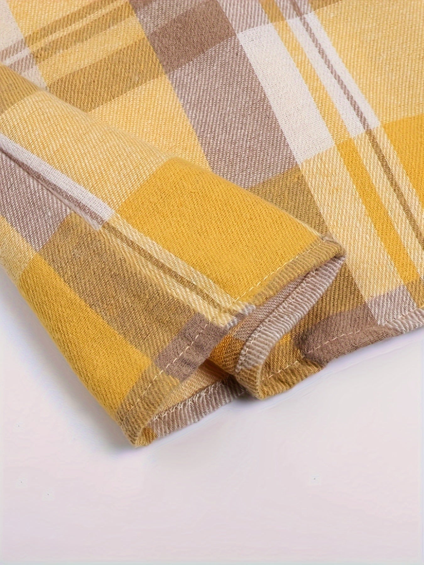 Long-sleeve plaid shirt cuff in yellow, tan, brown, and white