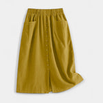 Yellow midi skirt with elastic waistband, front button placket, and side pockets.