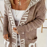 Light gray knit cardigan with white geometric trim and open front, long sleeves, pockets
