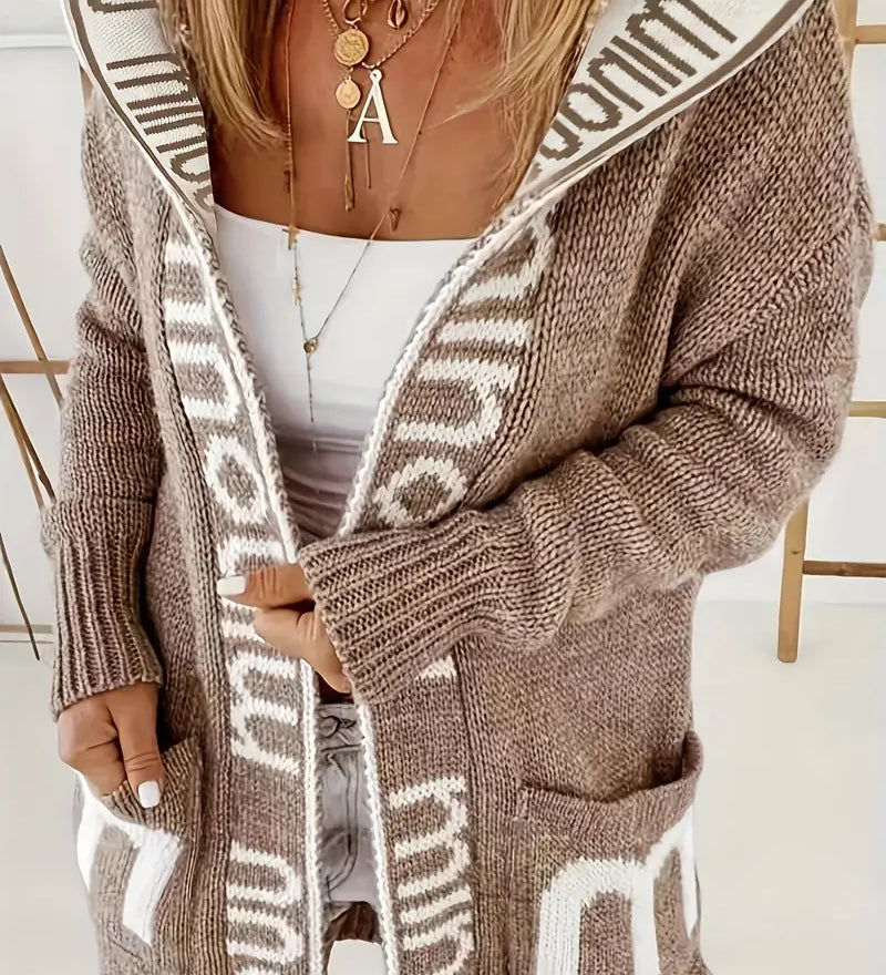 Light gray knit cardigan with white geometric trim and open front, long sleeves, pockets