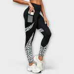 High-waist black workout leggings with white leopard side panel stripes