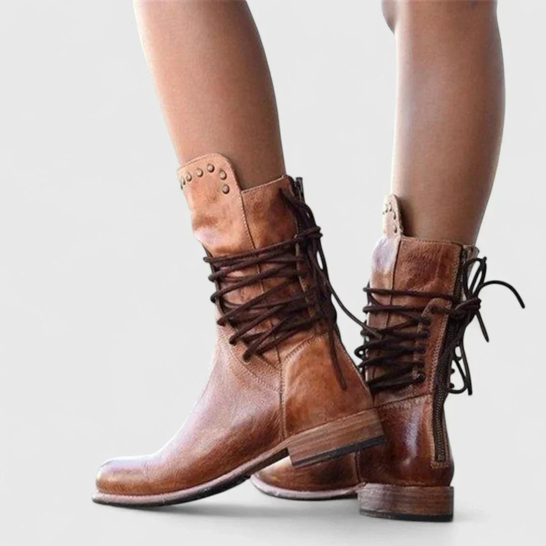 Brown leather lace-up ankle boots with ankle collar tabs and low stacked heel