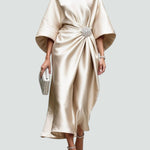 Cream satin long evening dress with draped batwing sleeves and jeweled waist brooch.