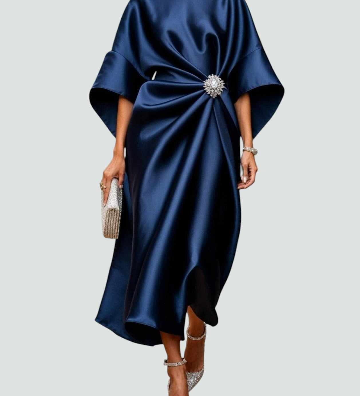 Navy satin long evening dress with draped batwing sleeves and jeweled center brooch.