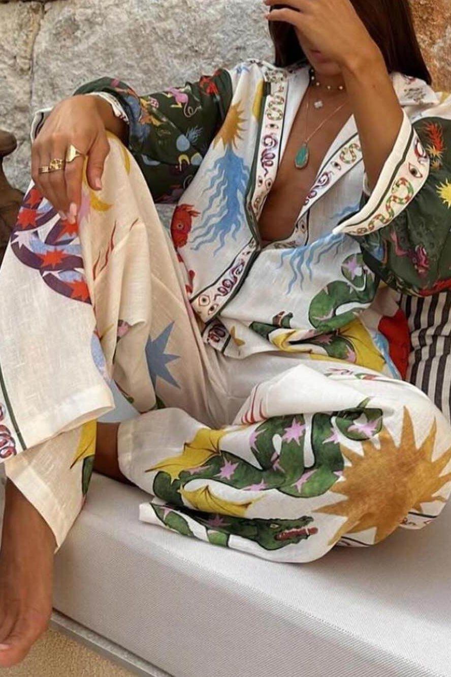 Two-piece set in cream base with multicolor print, V-neck shirt and wide-leg pants