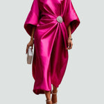 Fuchsia satin long evening dress with draped batwing sleeves and jeweled waist brooch.