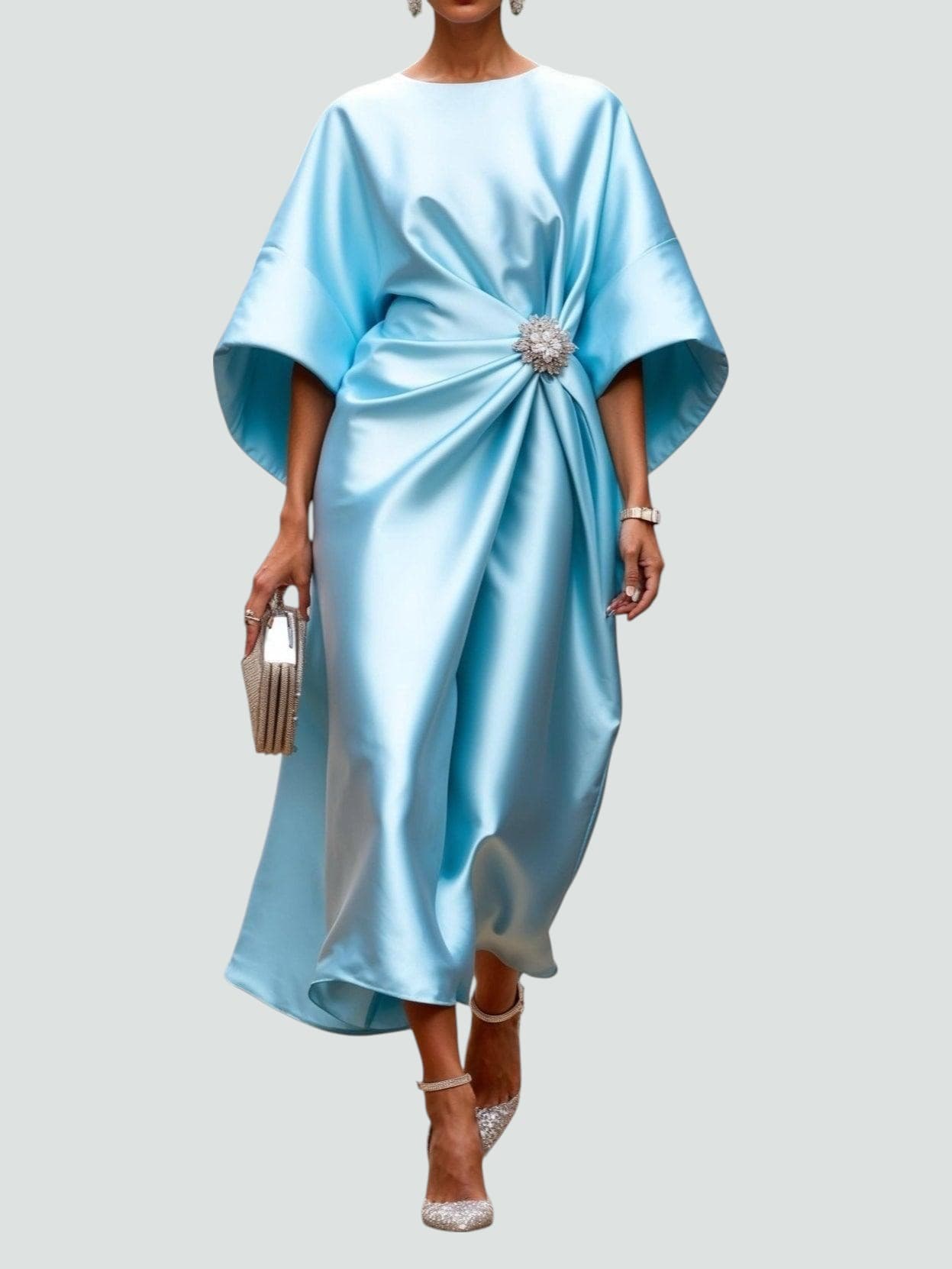 Light blue satin long evening dress with draped batwing sleeves and jeweled waist brooch.