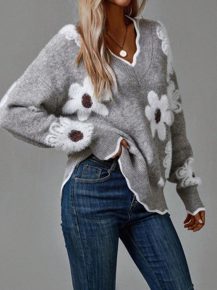 Gray floral V-neck sweater with white flowers, ribbed cuffs, and knit hem