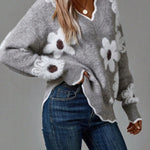 Gray floral V-neck sweater with white flowers, ribbed cuffs, and knit hem