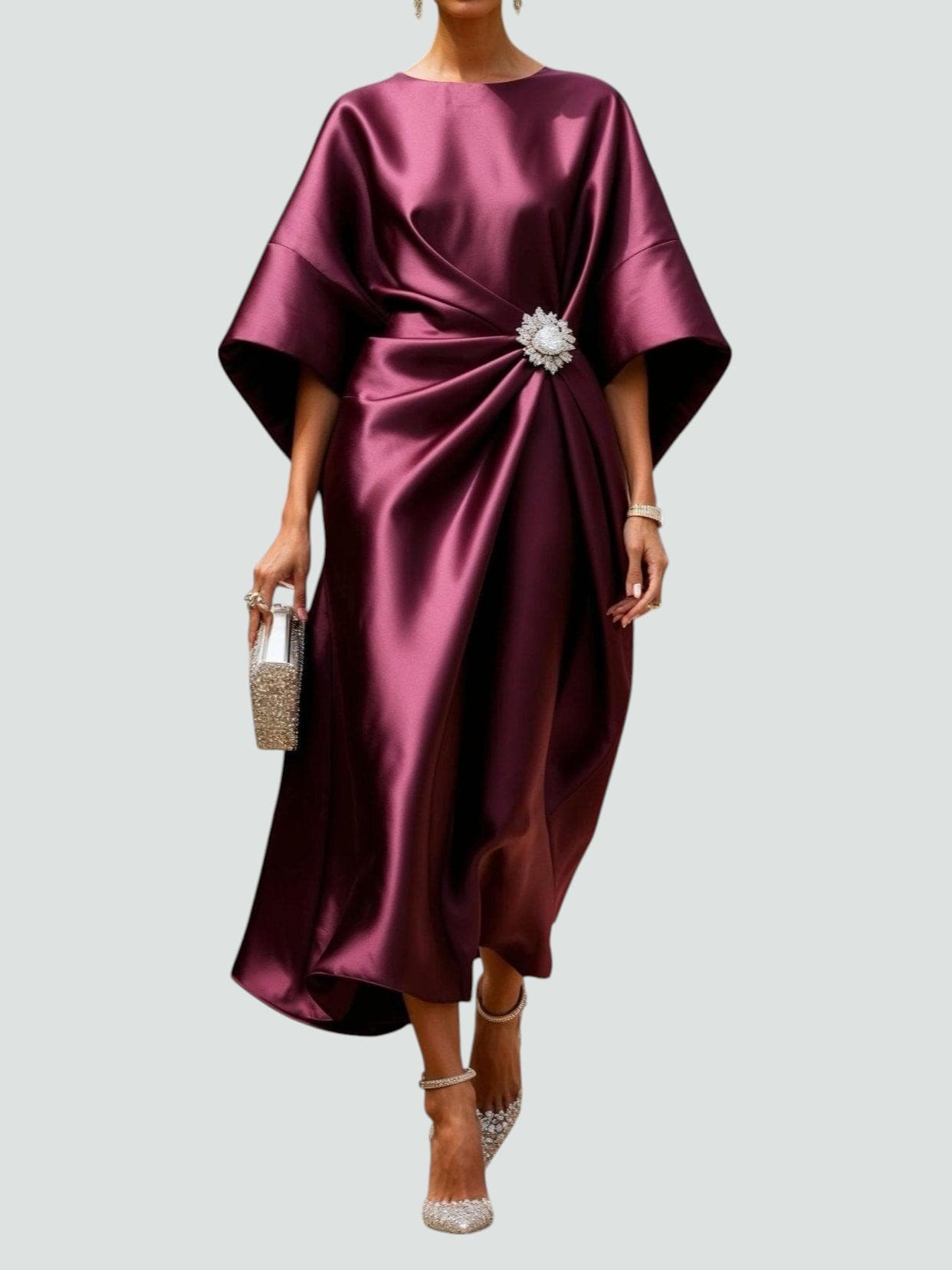 Burgundy satin long evening dress with draped batwing sleeves and jeweled waist brooch.