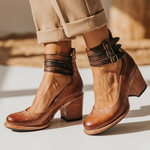 Rust-brown leather heeled ankle boots with two buckle straps and block heel
