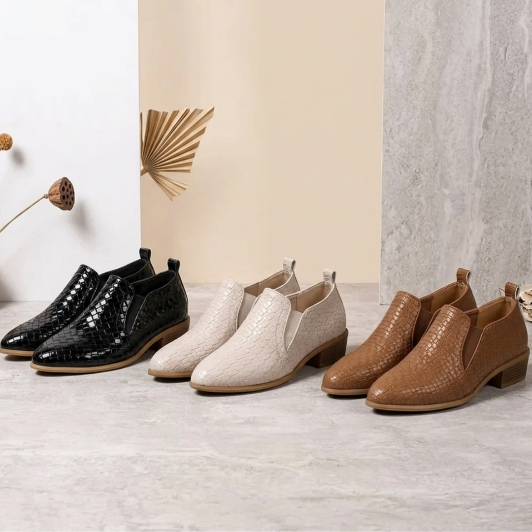 Assorted textured ankle boots in black, white, beige, and brown with block heels