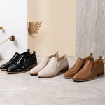 Assorted textured ankle boots in black, white, beige, and brown with block heels