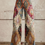 Front-view boho wide-leg pants with multicolor geometric tribal print on light denim