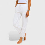 White elastic linen jogger pants with drawstring waist and cuffed ankles