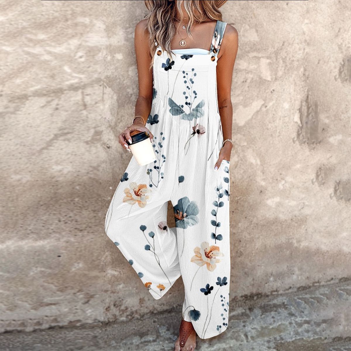 Loose printed overalls, sleeveless white with blue and brown floral print, wide legs