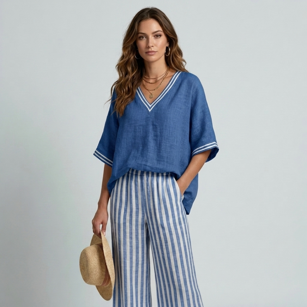 Women's blue V-neck top with contrast trim and striped wide-leg pants