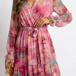 Luzia floral wrap dress close-up: V-neck bodice and tied waist belt, tiered ruffles
