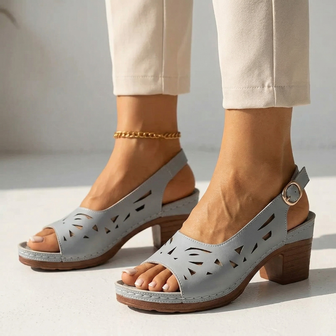 Light gray orthopedic slide sandals with perforated cutouts and block heel