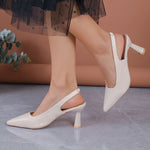 White orthopedic pointed-toe slingback heels with mid block heel and wide strap