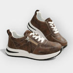 Anatomical brown sneakers with white laces, side zipper, and white rubber outsole.