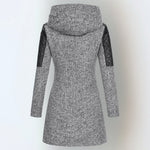 Women’s winter parka coat in light gray with hood and quilted black sleeves, back view