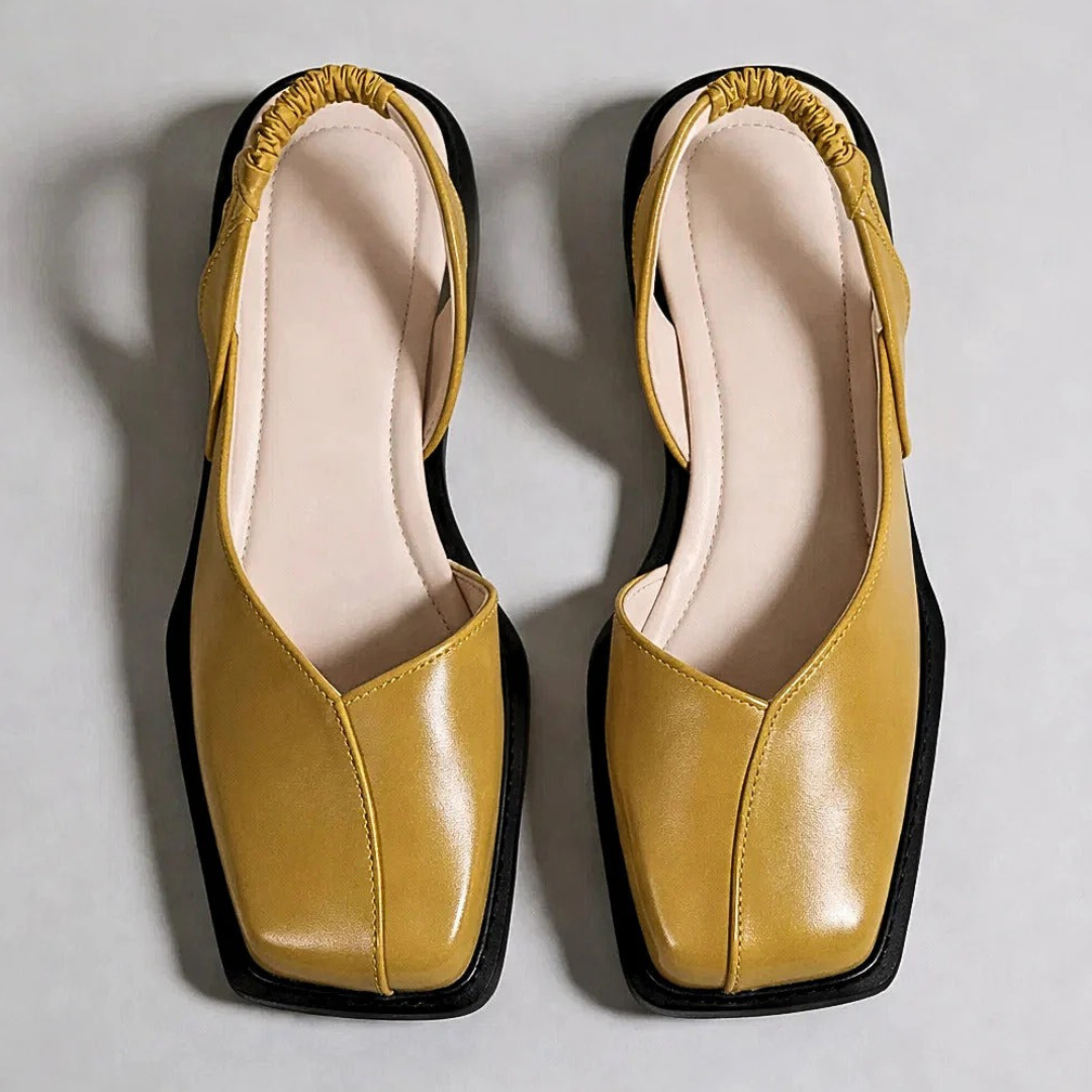 Pair of Emanuela square-toe moccasins in mustard with black trim and outsole