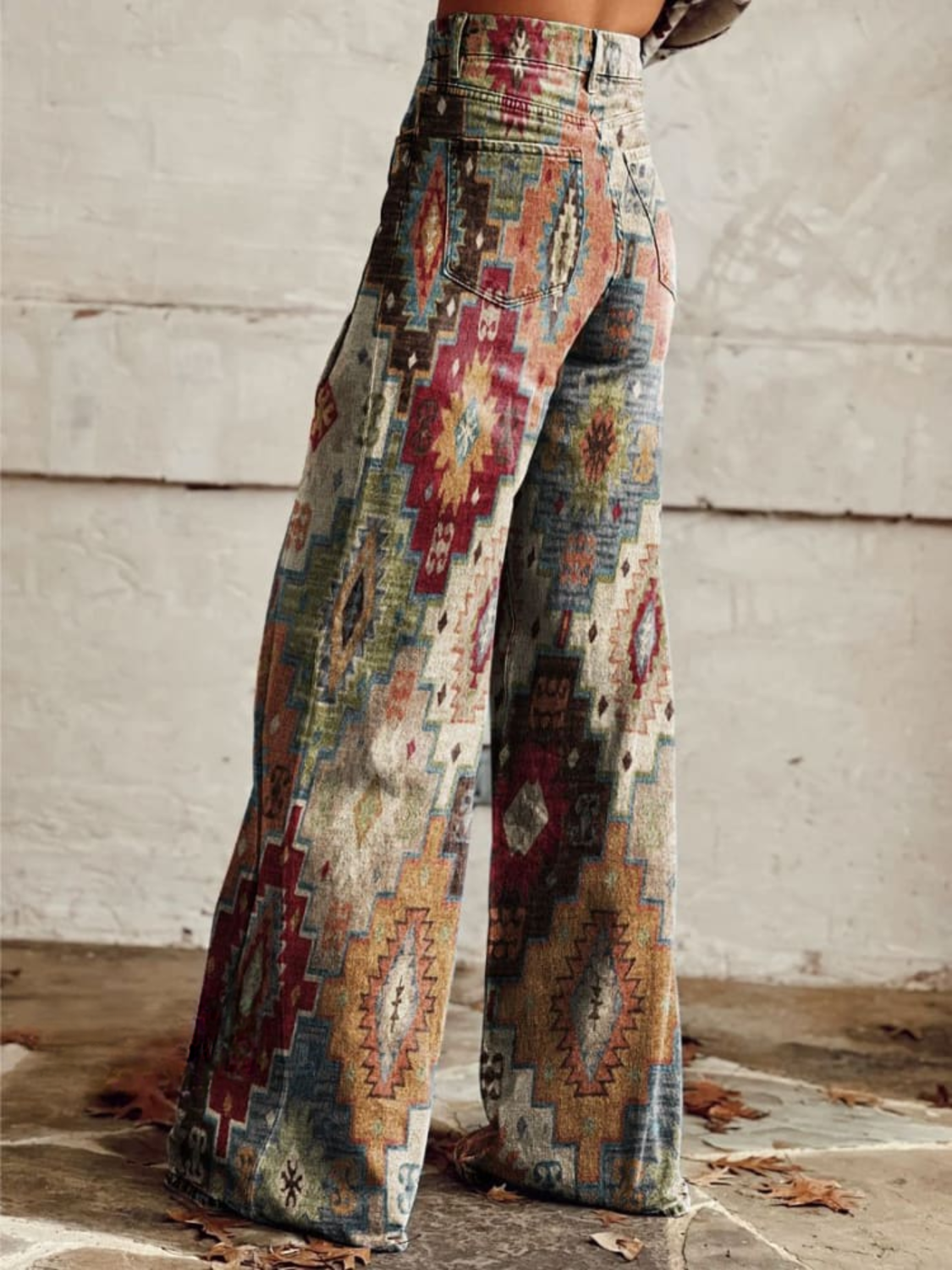 Boho wide-leg trousers in light denim with multicolor geometric tribal print, side view