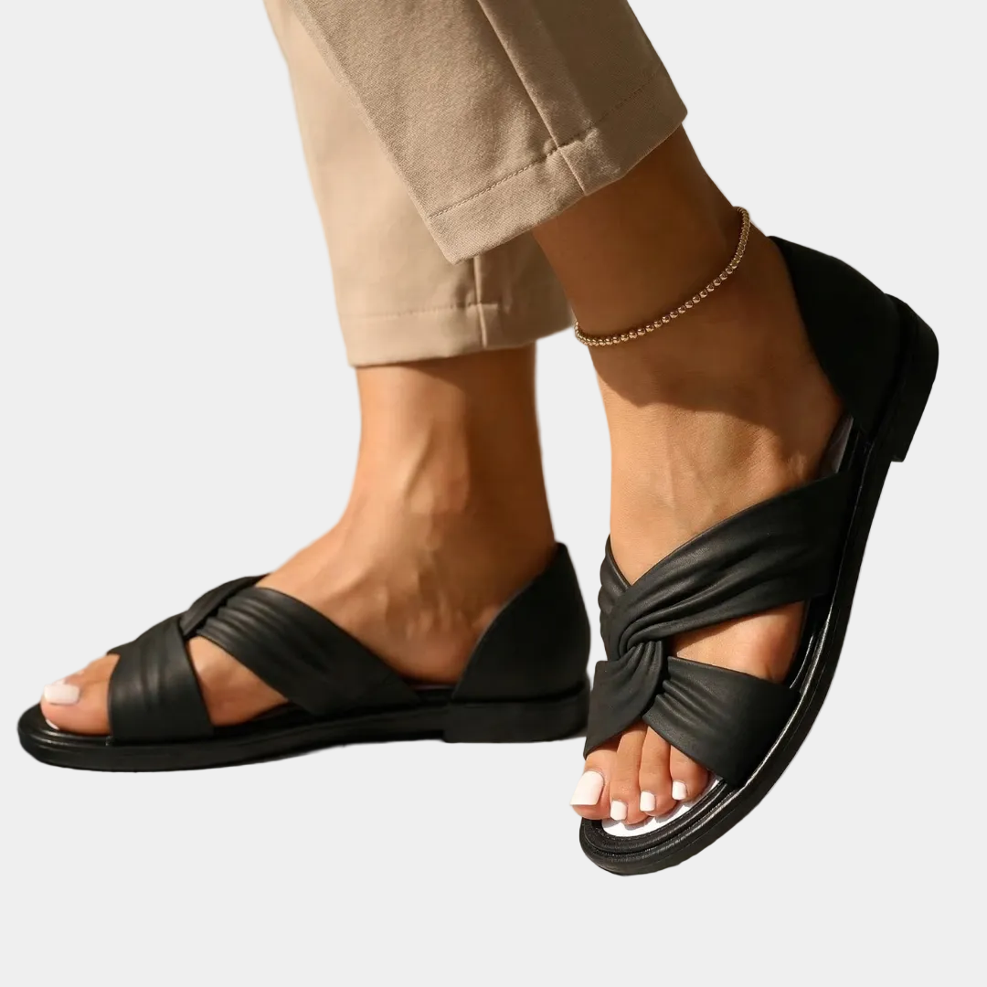 Black orthopedic slide sandals with twisted strap and ankle chain, open toe