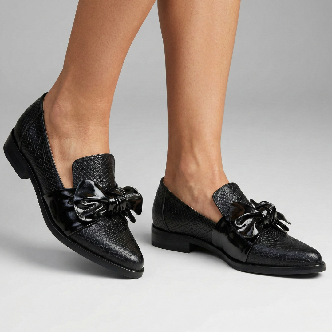 Black loafer with textured upper and knot bow on vamp, low heel