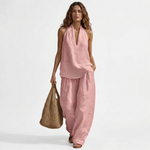 Two-piece V-neck linen set with sleeveless top and wide-leg pants in dusty pink.
