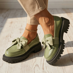 Water-resistant loafers in green with bow across vamp and thick rubber tread