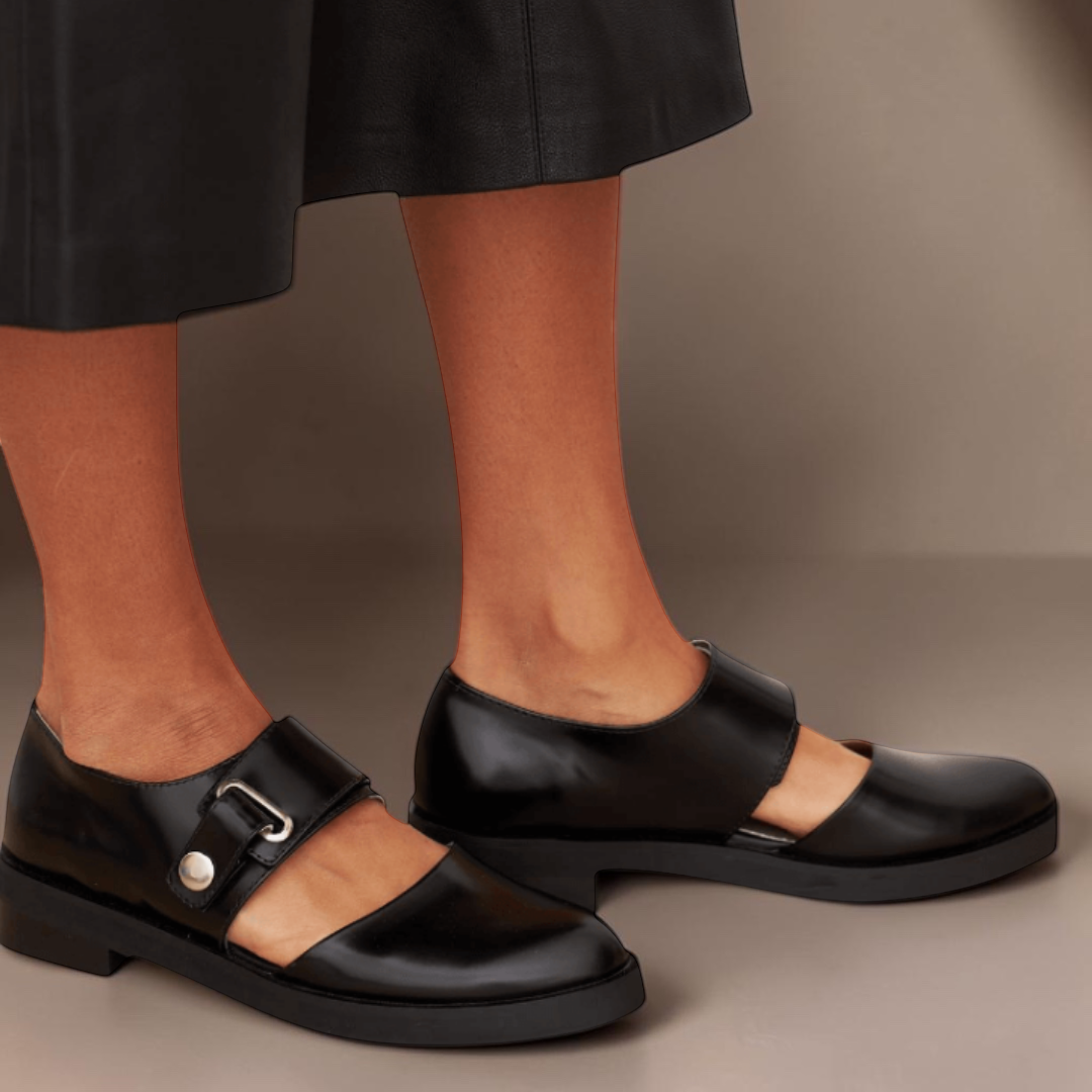 Black Mary Jane flats with adjustable buckle strap and rounded toe