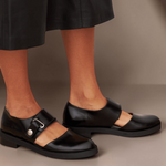 Black Mary Jane flats with adjustable buckle strap and rounded toe